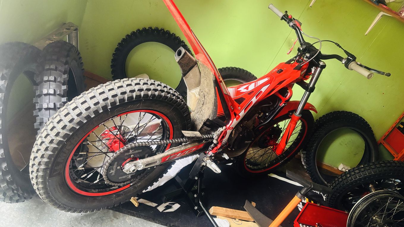 En rød motorsykkel på en treflate